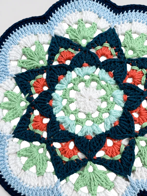 blue green floral round fan close up detail
