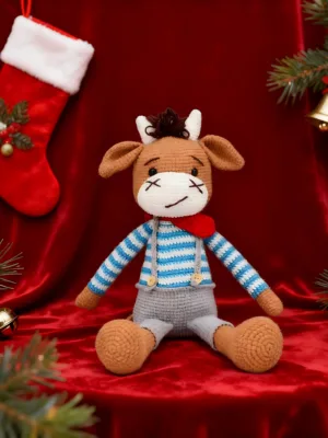 Hand crocheted calf doll Christmas red fabric festive scene