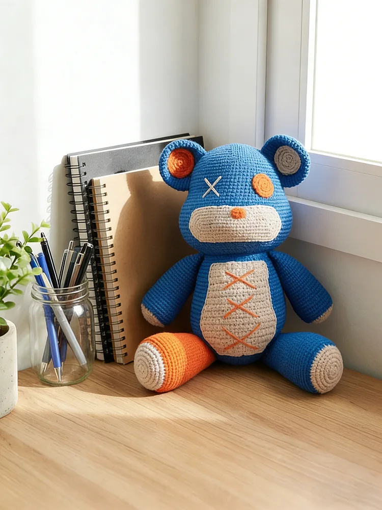 Crochet bear Amigurumi on wooden bookshelf