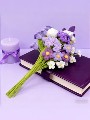 Crochet purple flower bouquet on book