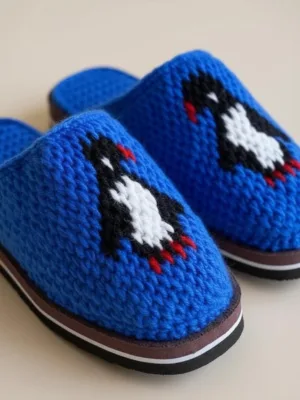Penguin pattern on blue crochet slippers