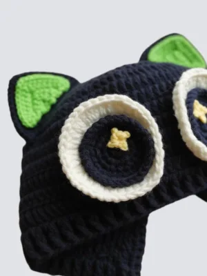 close up of black cat baby hat eye detail