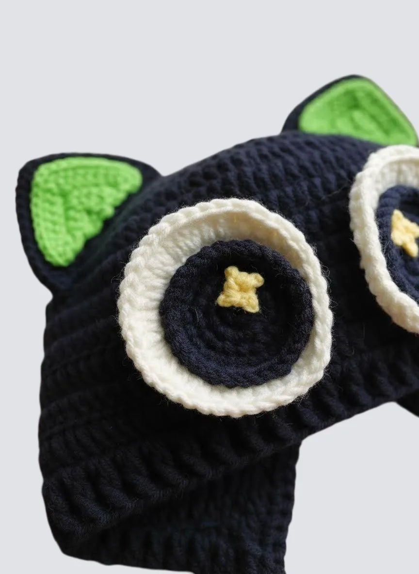 close up of black cat baby hat eye detail