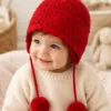 crimson bobble earflap beanie hanging display